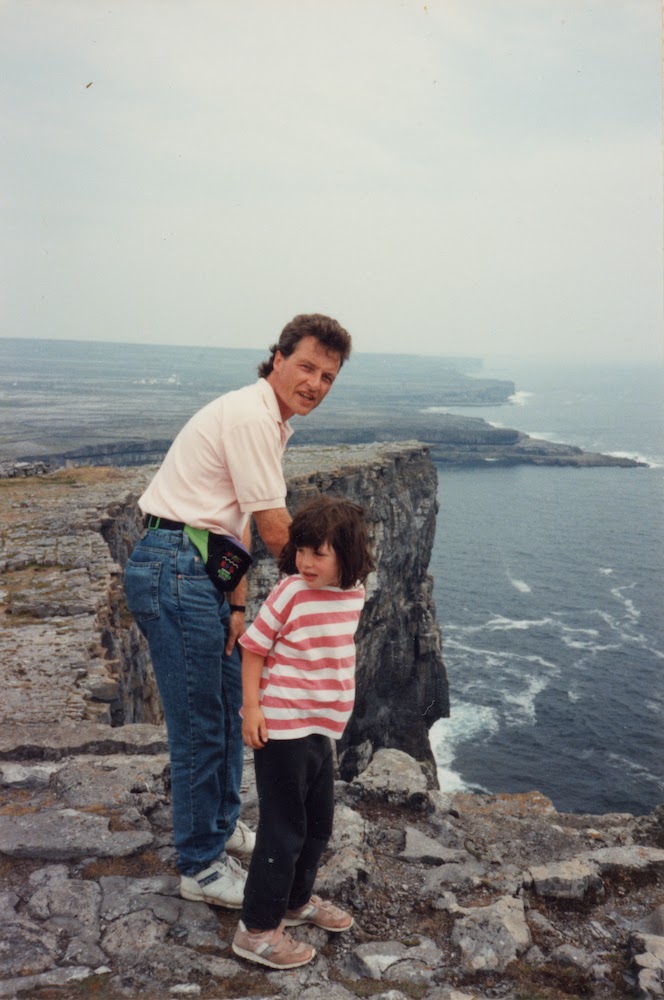 Inishmore, Francis Atkinson with daughter Arainn, at Inishmore prehistoric cliff-top fort, Aran Islands, Galway Bay, Republic of Ireland. C.1990