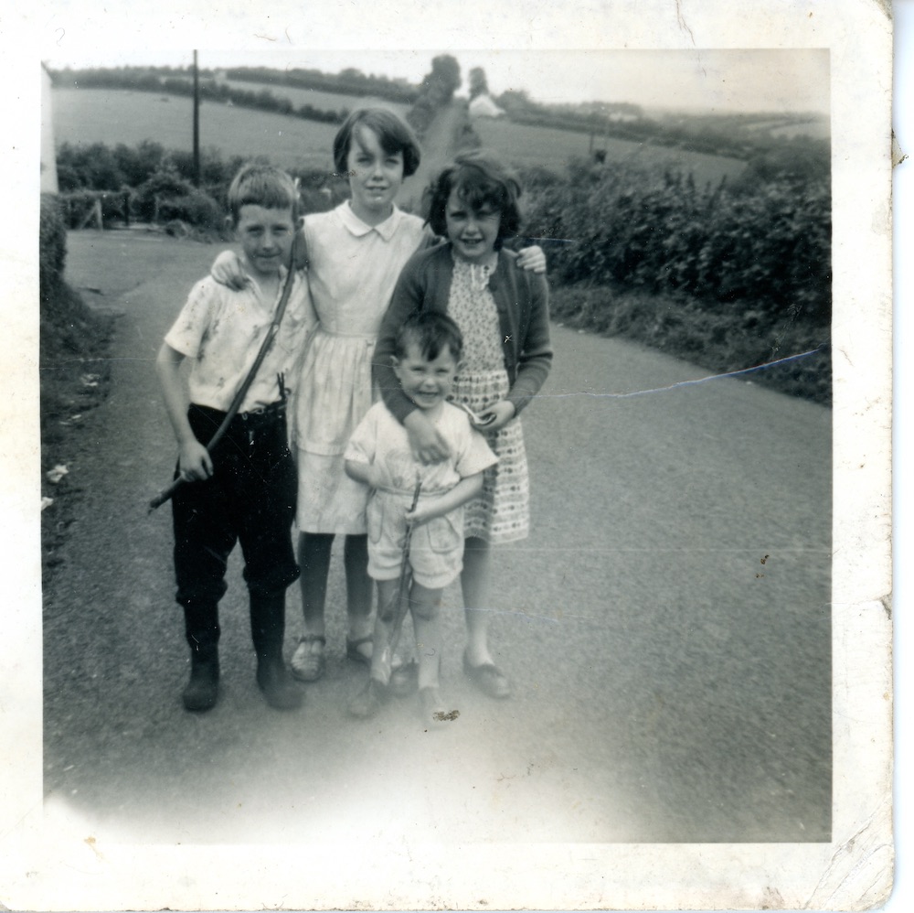 Michael with three of his siblings outside their home, Gulladuff, County Derry, 1961